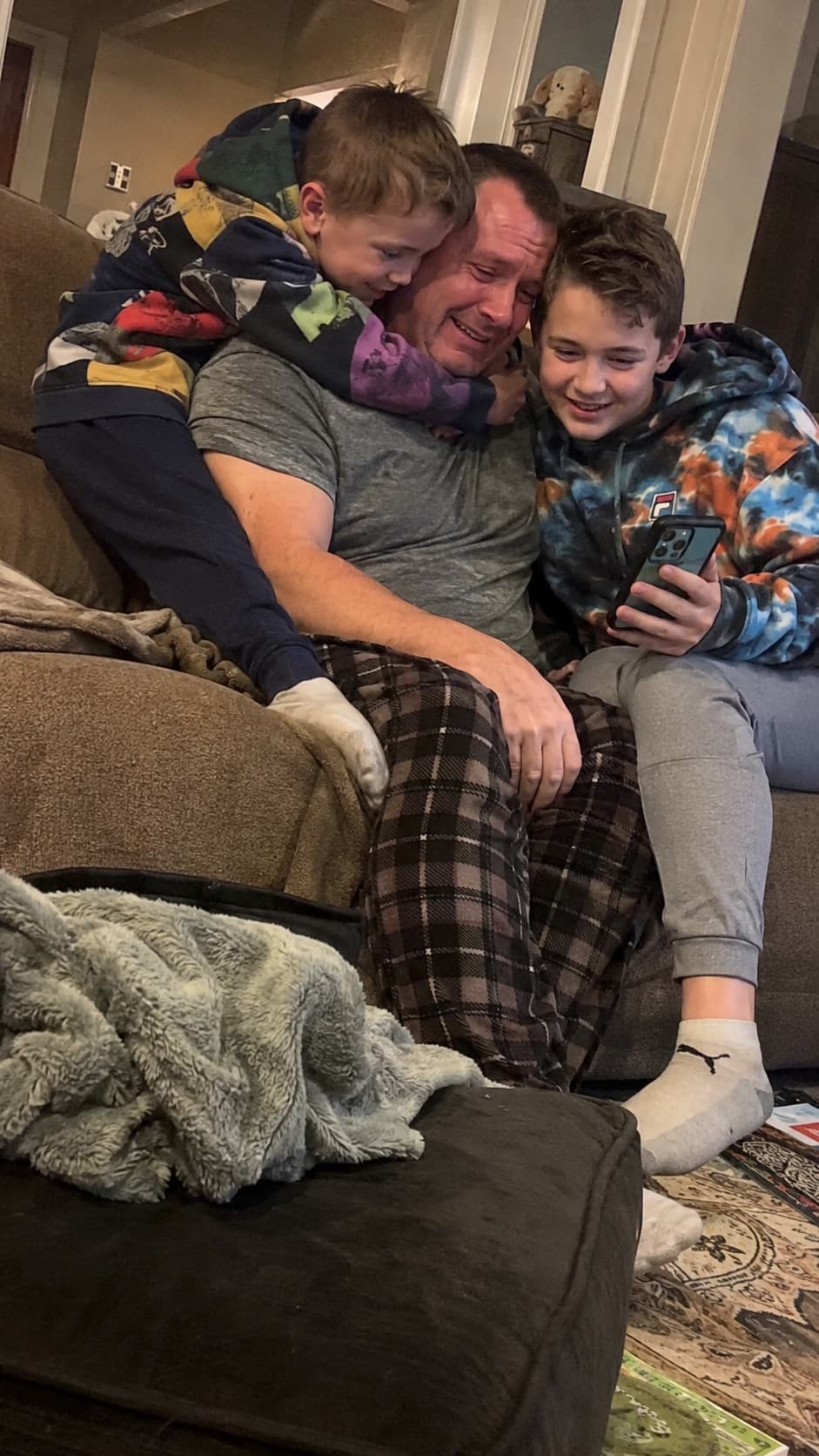 Father and sons reacting to a family song